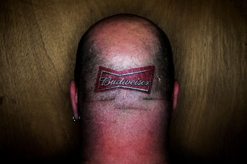 Rick Wynn proudly showcases his beer of choice with a tattoo on his head.